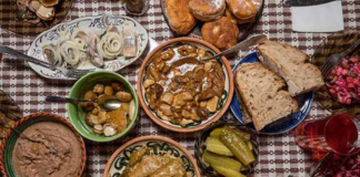 Abundância na mesa natalícia e palha para lembrar Jesus